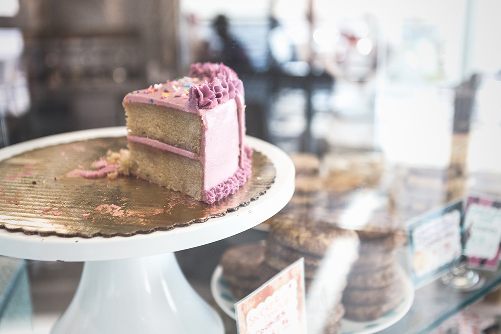 slice of cake in a pastry case 