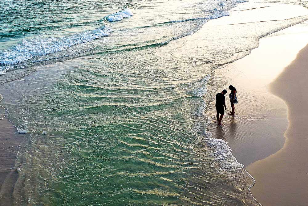 A couple taking a walk at RAK Beach