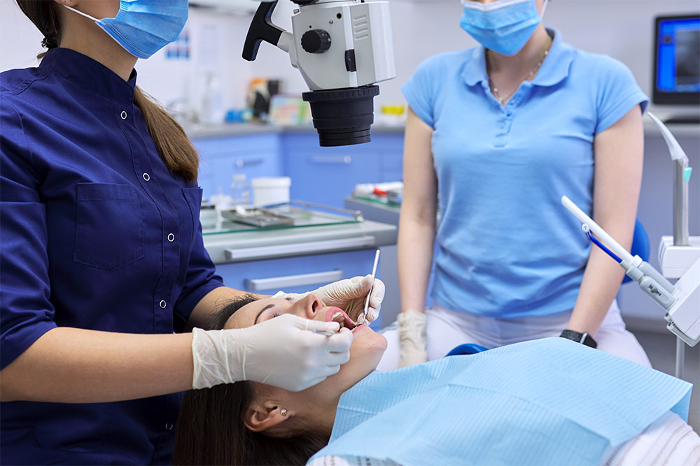 A dentist performing a dental procedure in a clinic