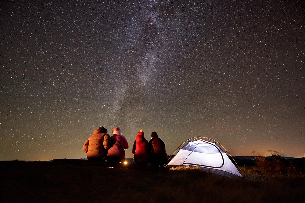 A group of friends stargazing in an oasis in Abu Dhabi