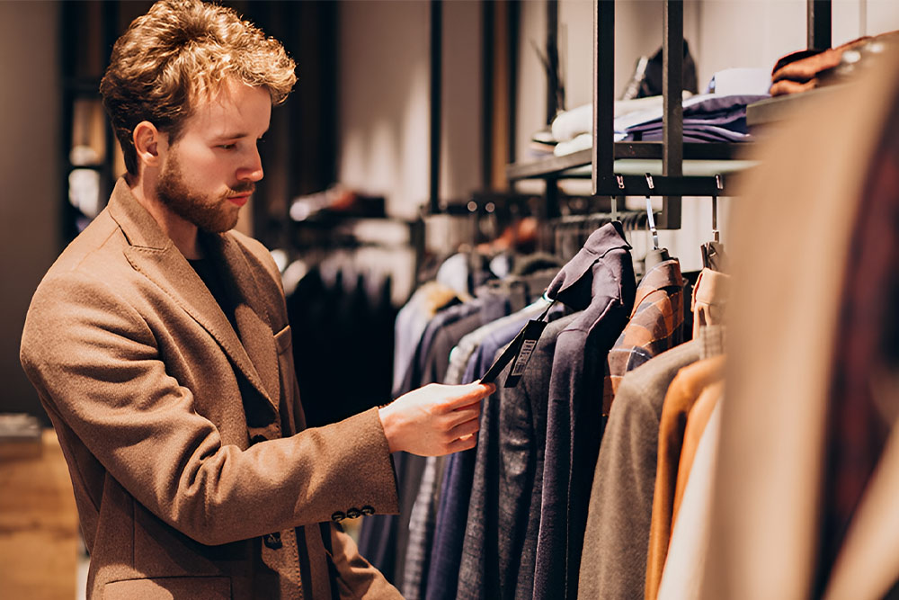 Man Checking Price Tag on a coat