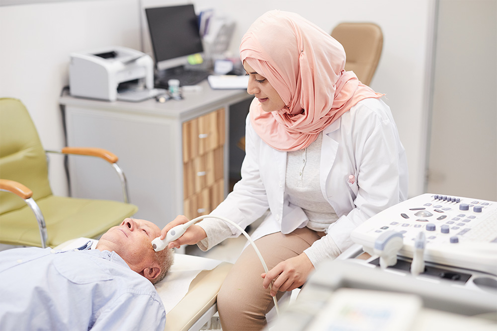 A female doctor treating an elderly patient 