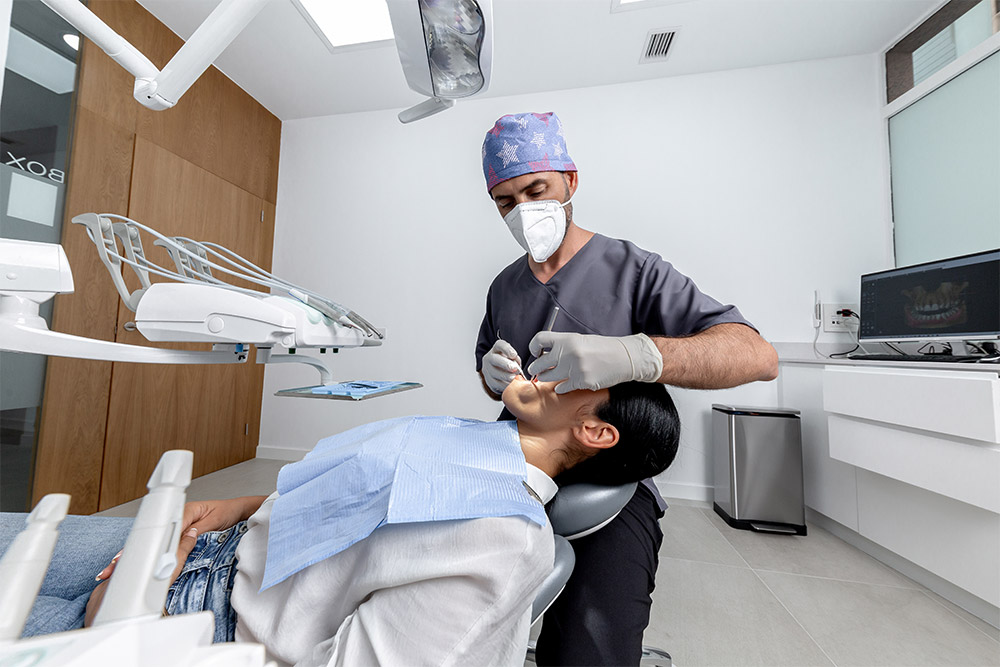 A male dentist checking a patient at one of the best dental clinics in Dubai 