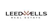 LEED WELLS REAL ESTATE logo image