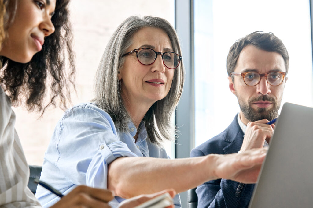 Group of professionals collaborating on a high-impact sales presentation, with a focus on engaging developers and investors, highlighting strategic planning and teamwork.