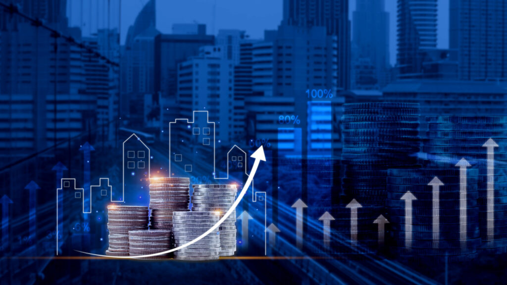 Stacks of coins in the foreground with upward-pointing arrows, indicating financial growth and investment. Behind the coins are transparent outlines of buildings and percentage values, symbolizing real estate and economic development within a modern cityscape.